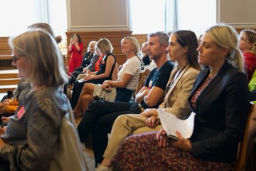 Participants seated in the chamber, listening