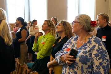 Contributors standing and engaging during the session