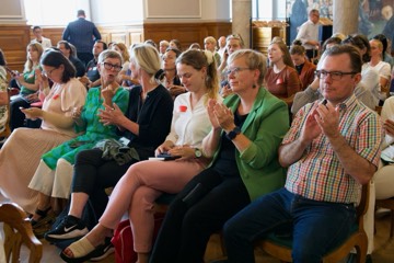 Participants applauding in the front rows
