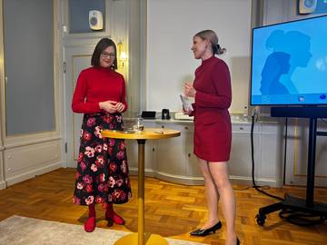 Two speakers in conversation on stage