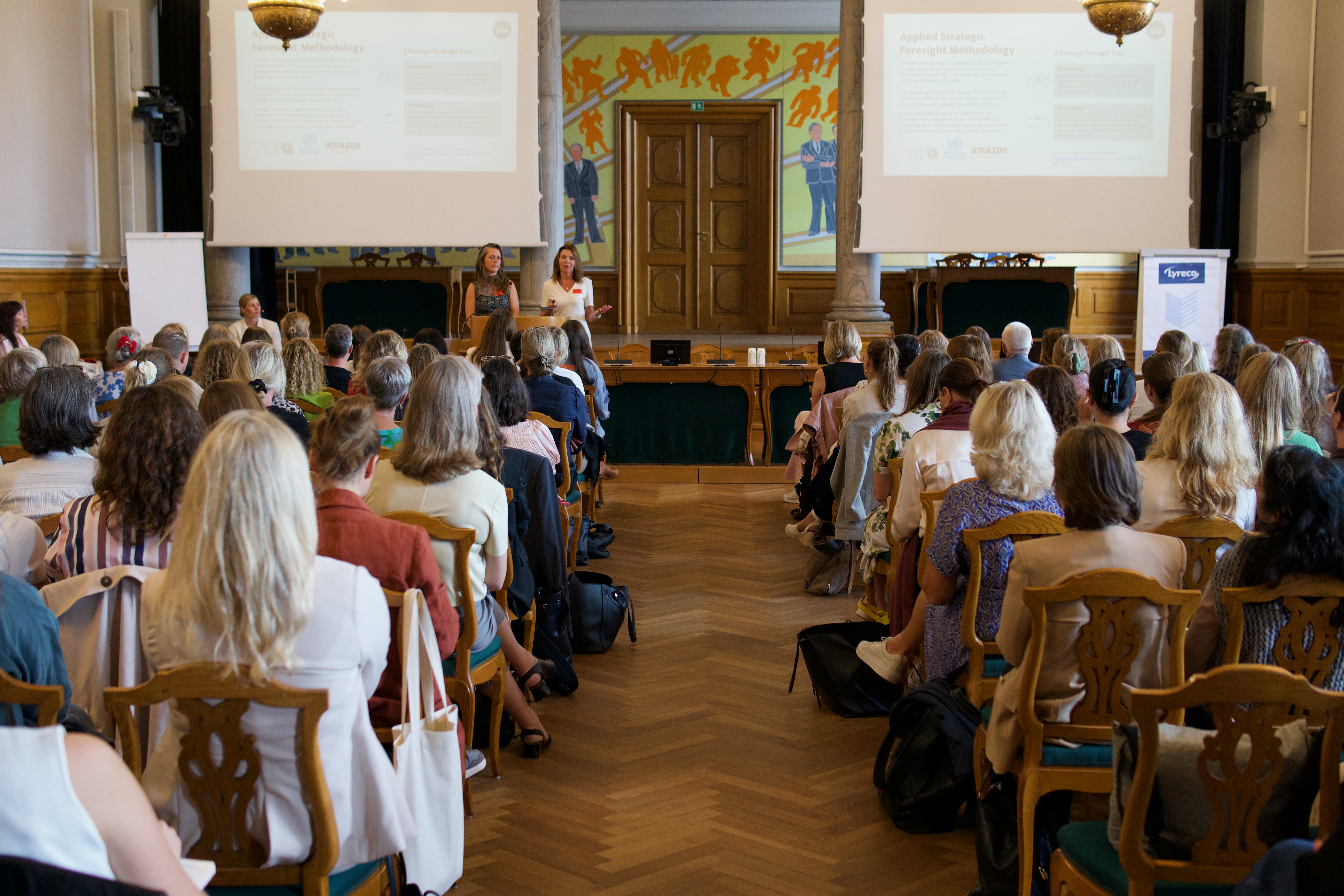 Presenters addressing the assembly at the Danish Parliament